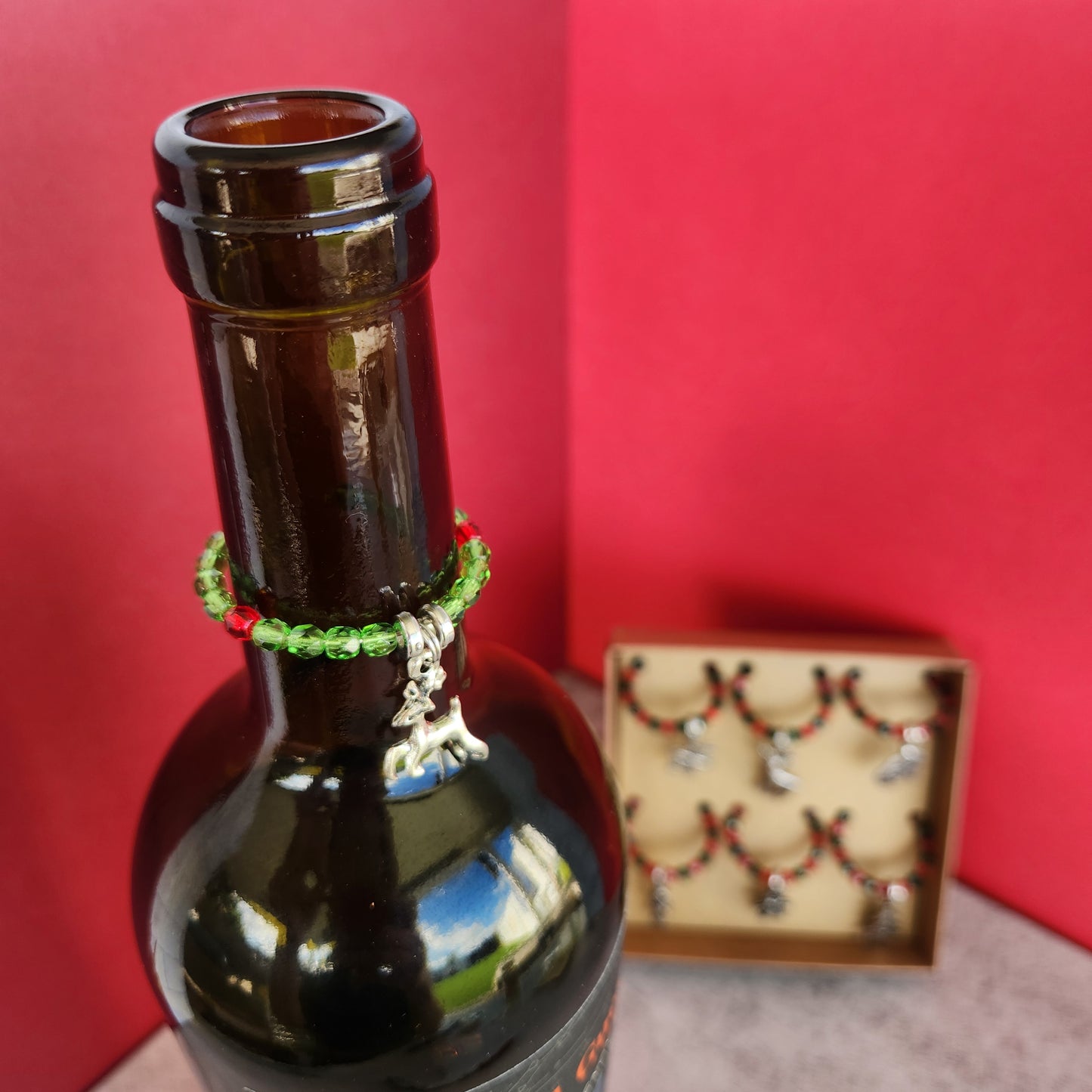 Silver Reindeer Wine Glass Charm on a Wine Bottle Neck, Featuring Red and Green Beads, Perfect for Christmas Decor in Phoenix