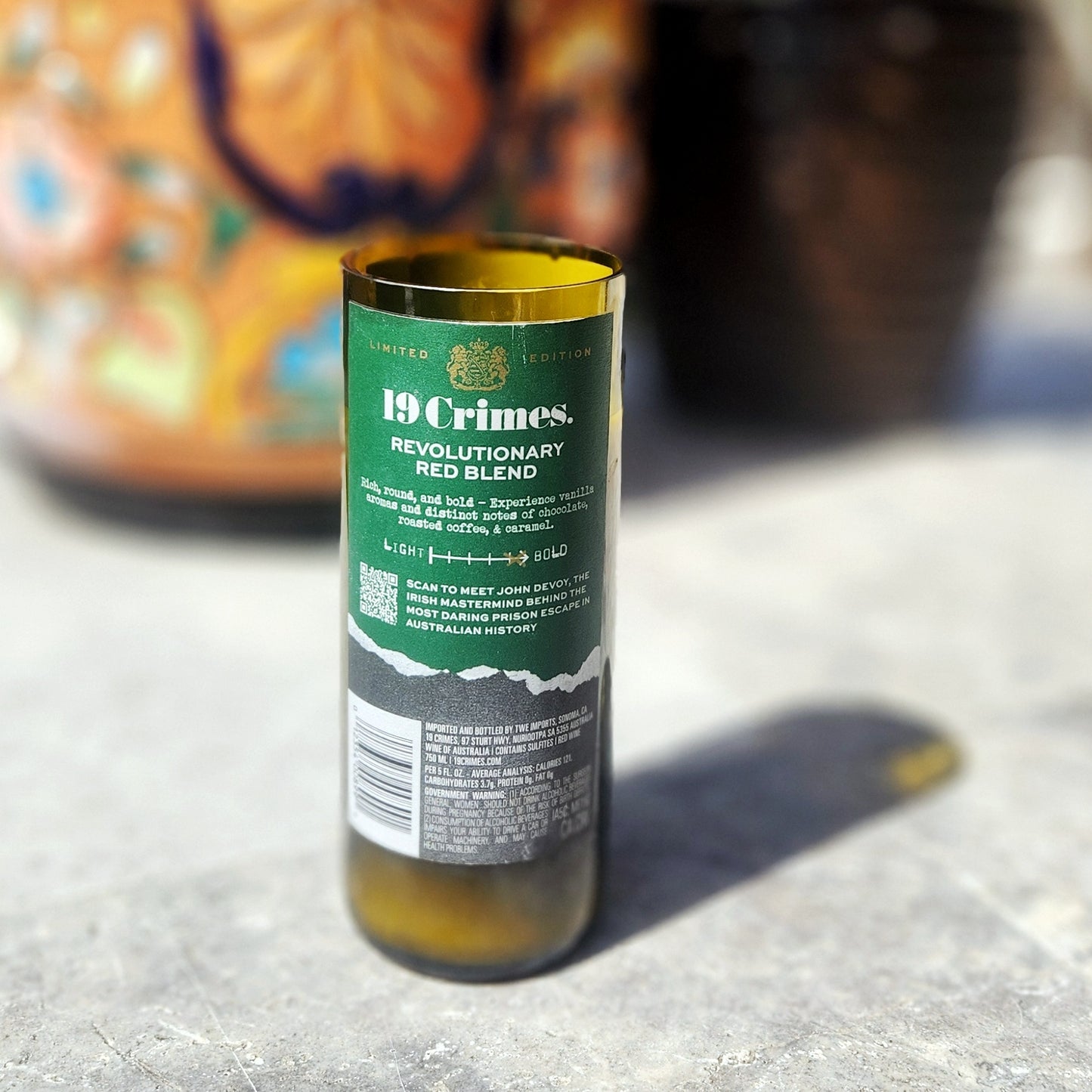 Back label of a 19 Crimes Revolutionary Red Blend wine bottle, now repurposed as a sustainable candle filled with eco-friendly coconut soy wax.