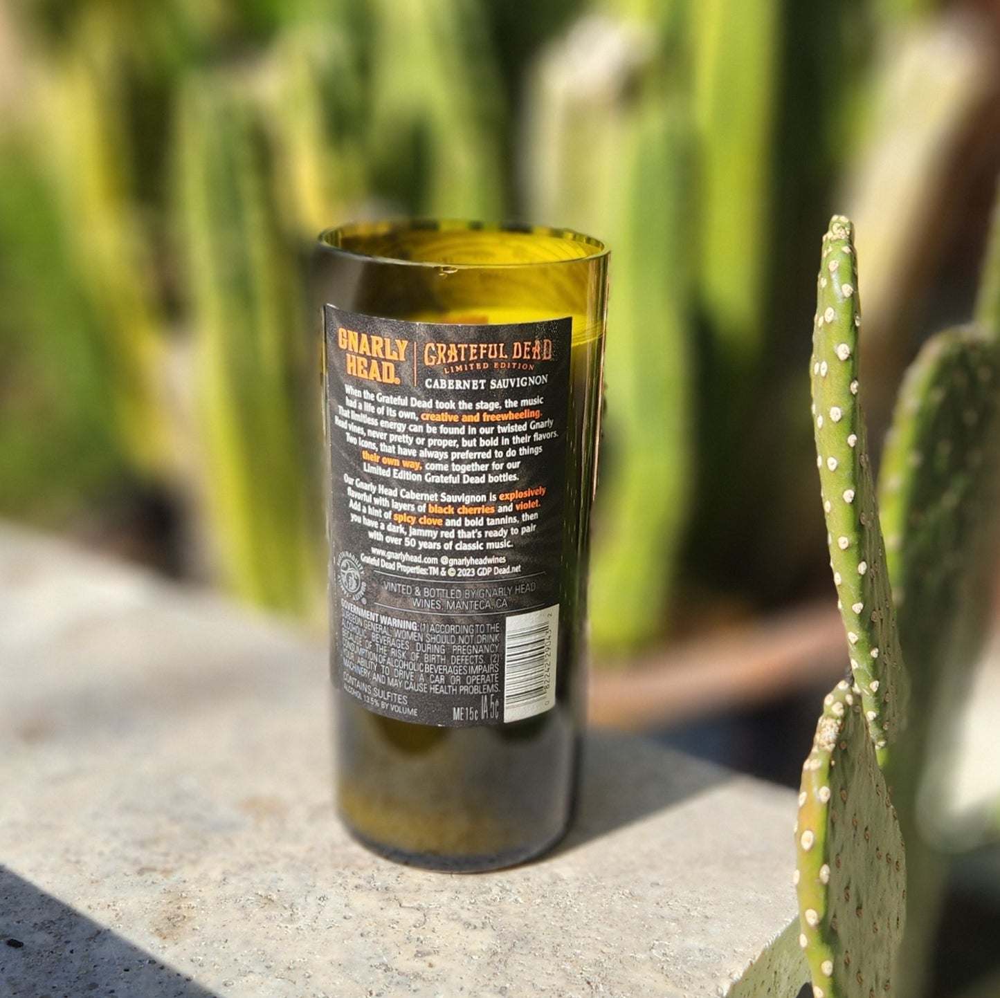 Back label of the limited-edition upcycled wine bottle candle, made with sustainable materials and filled with coconut soy wax for a healthier home scent.