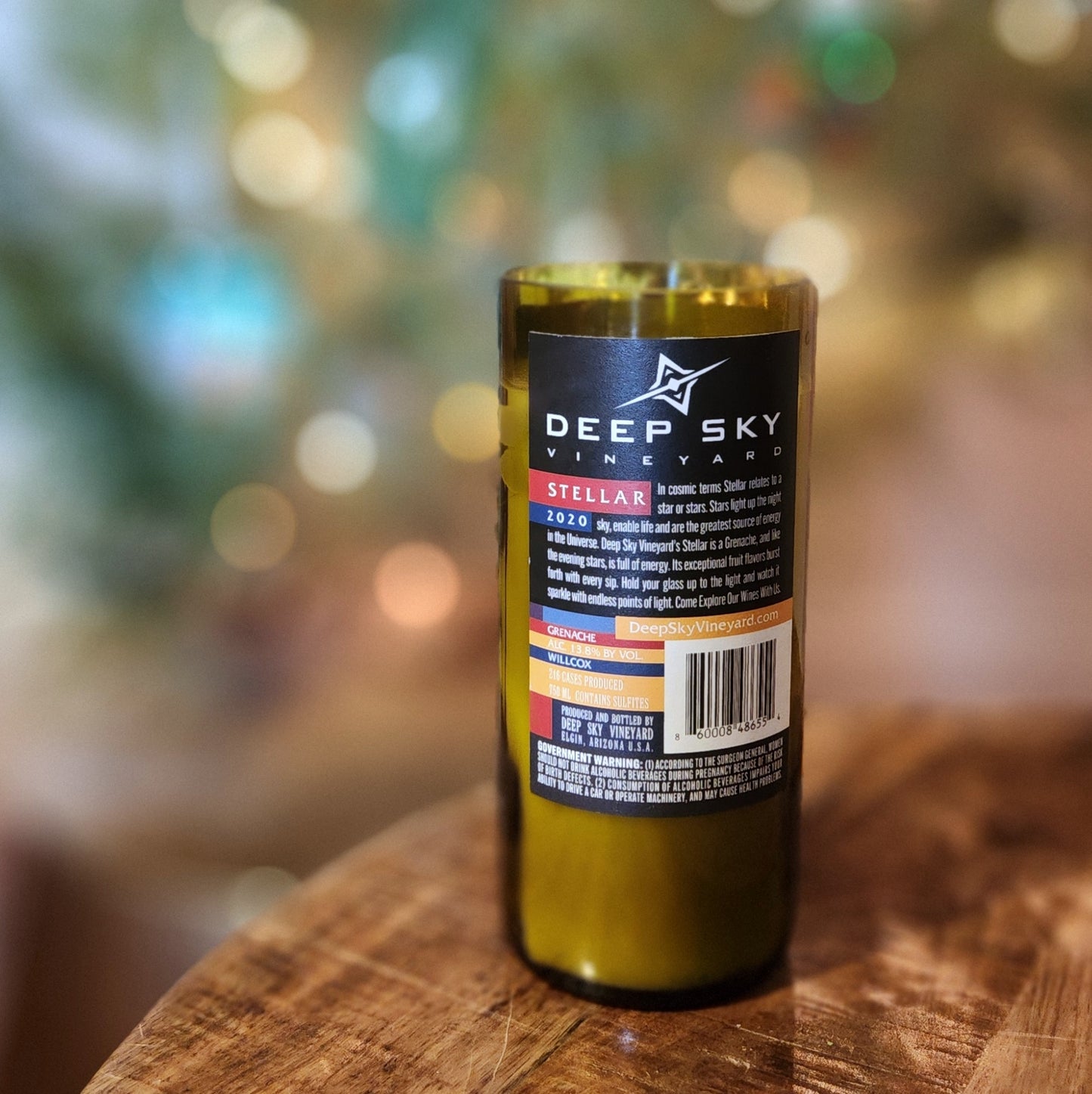 Back view of a Stellar R Deep Sky Vineyard wine bottle candle showing the original Arizona vineyard label, transformed into a coconut soy wax candle with a wooden wick and sustainable charm.