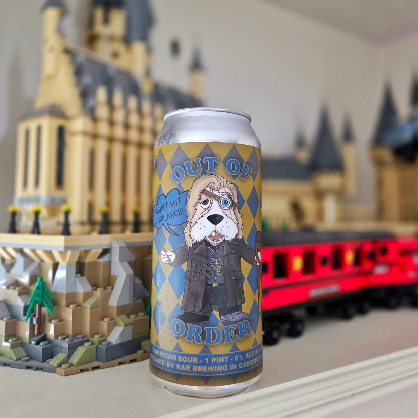 Front view of a recycled beer can candle made from a RAR Brewing “Out of Order” can, featuring a cartoon dog resembling a wizard with the words “Constant Vigilance!” This upcycled can candle blends whimsical artwork with hand poured, eco-friendly charm.