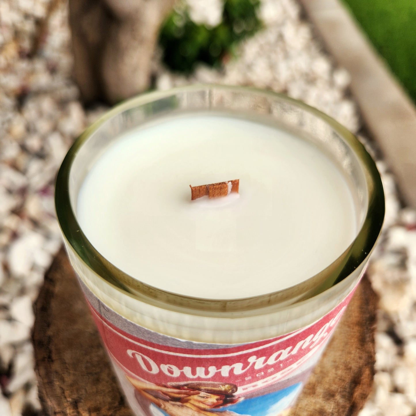 Close-up of the smooth glass rim and clean-burning wooden wick of a recycled wine bottle candle. The creamy coconut soy wax fills the vessel evenly, emphasizing the candle’s handcrafted, non-toxic composition.