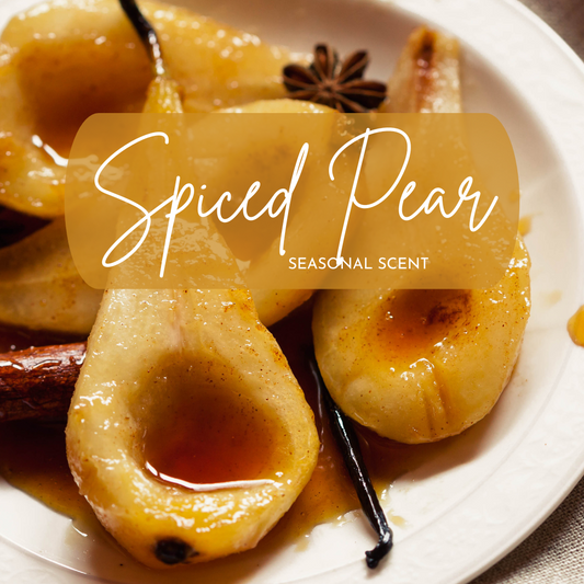Spiced pears on a plate with star anise and vanilla bean, labeled 'Spiced Pear Seasonal Scent'.