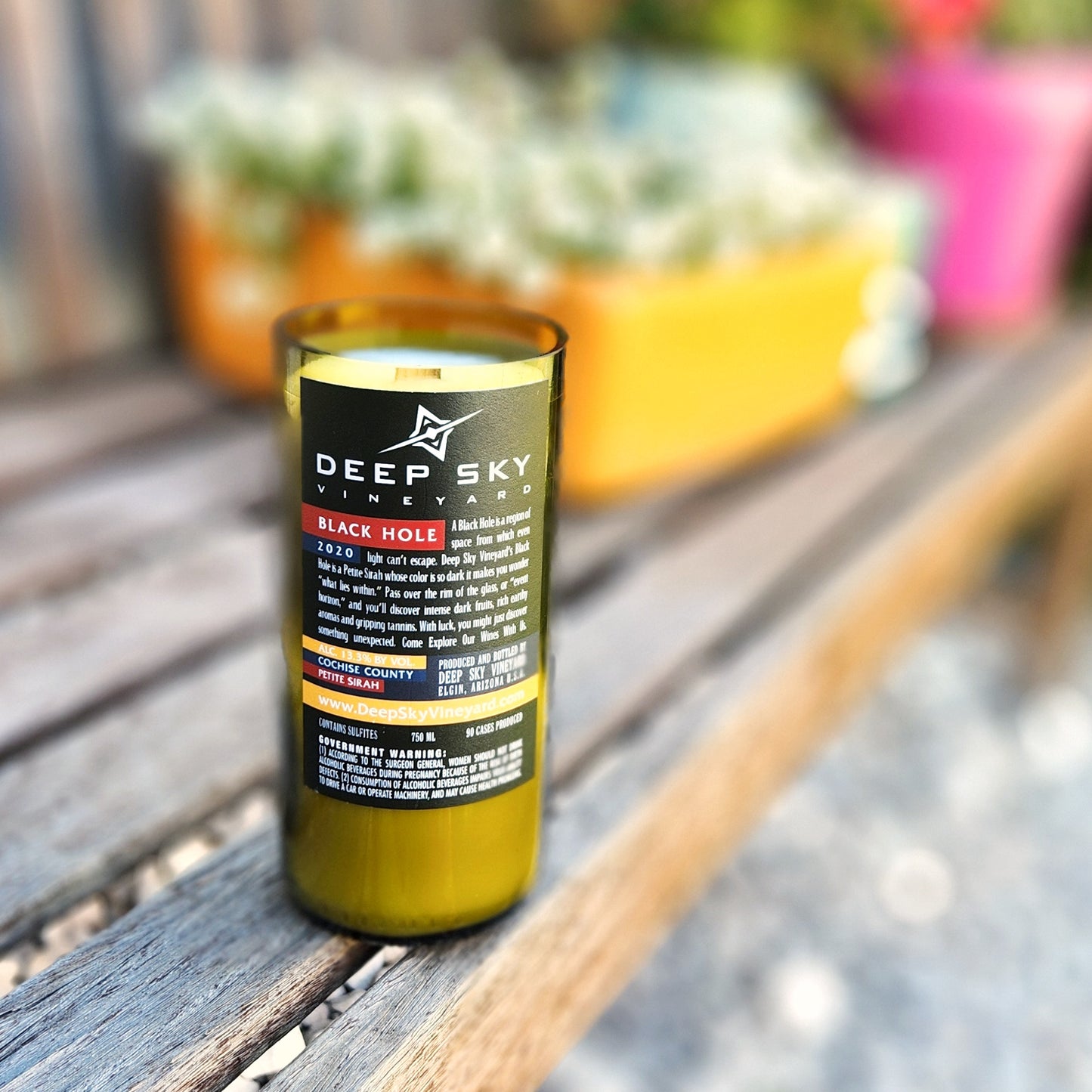Back of the eco-friendly wine bottle candle showcasing the original Deep Sky Vineyard “Black Hole” label. Repurposed into a clean-burning candle with creamy wax and a wooden wick.