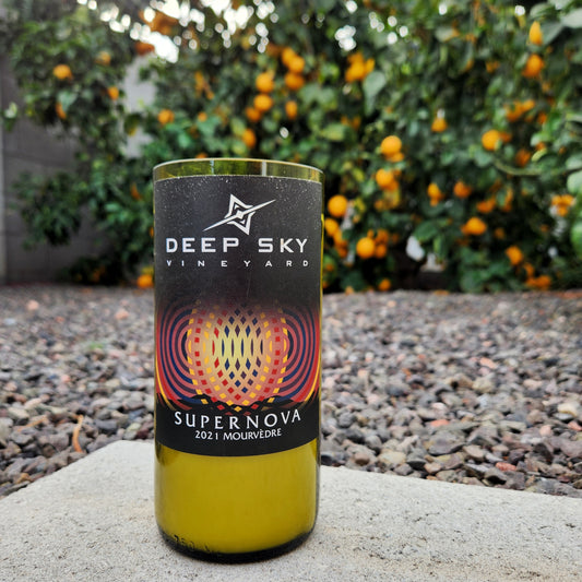 Eco-friendly wine bottle candle crafted in a recycled Deep Sky Vineyard bottle. Hand-poured with coconut soy wax, perfect for cozy home decor.