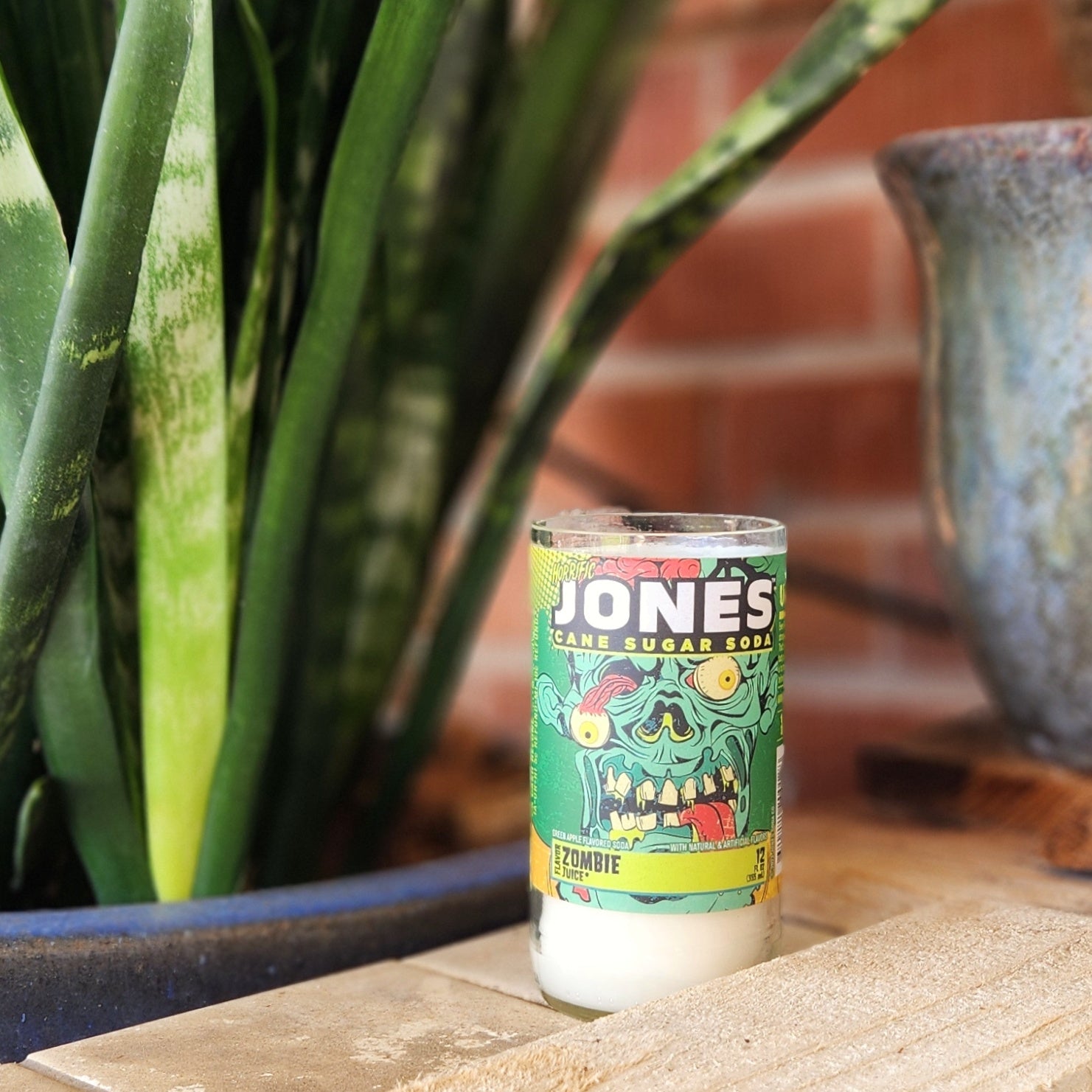 Add a quirky touch to your decor with this hand-poured candle in a recycled Jones Soda can. Featuring the vibrant and fun Zombie design, it’s a playful blend of sustainability and spook-tacular charm.