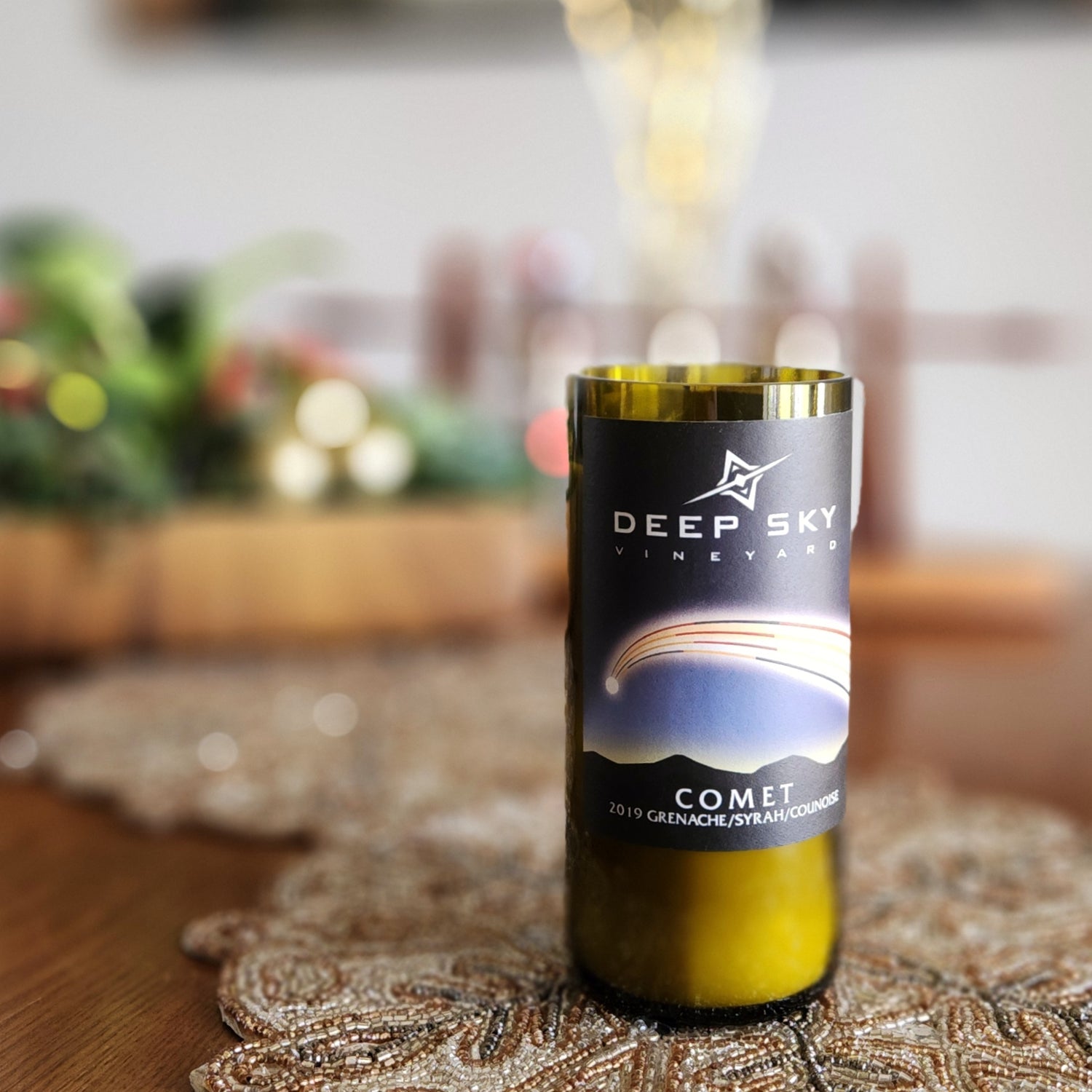 This unique candle, housed in a recycled Deep Sky Vineyard bottle, is perfect for adding a celestial touch to your home. Its elegant design makes it a stunning centerpiece or gift