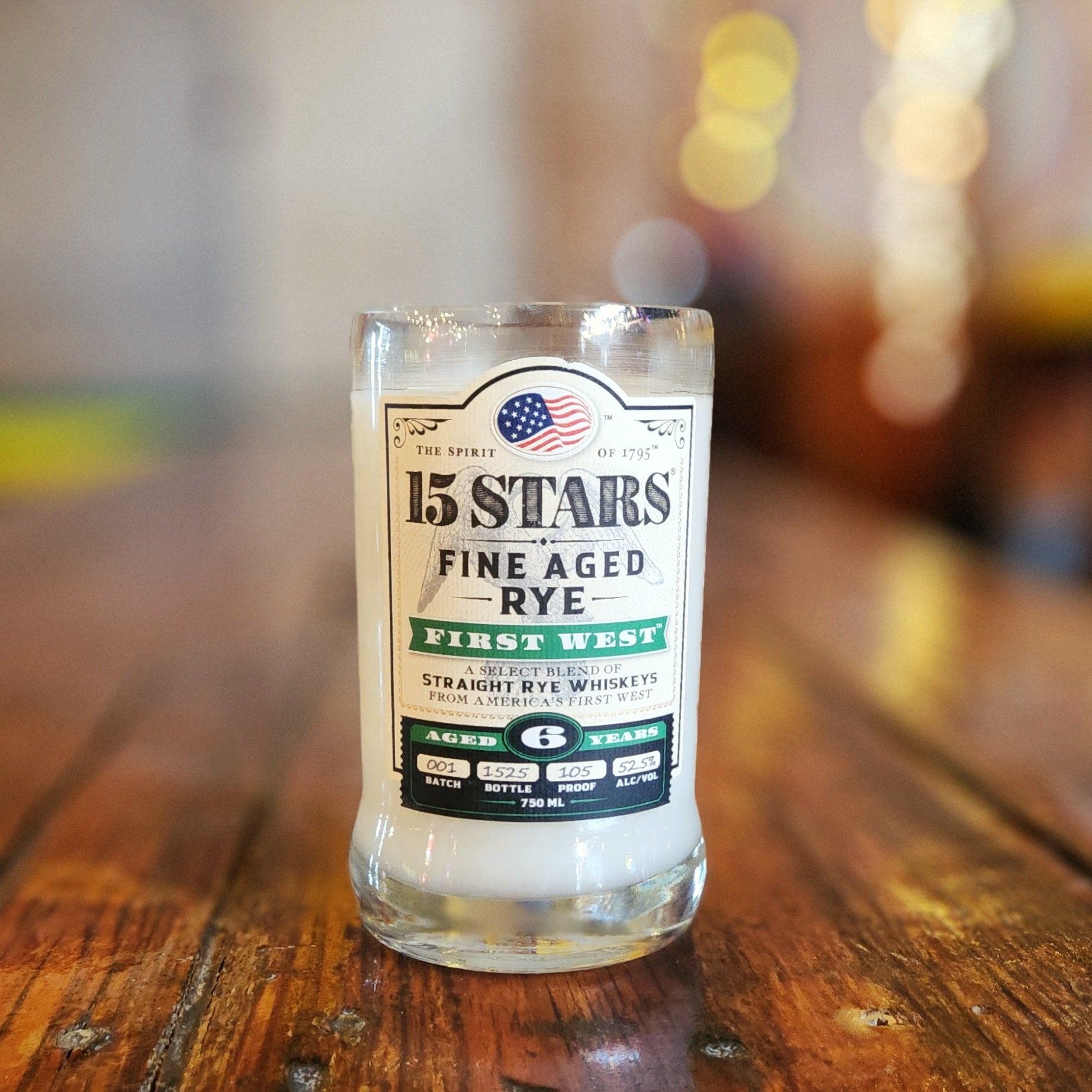 Upcycled bourbon bottle candle featuring the 15 Stars Fine Aged Rye label, filled with white coconut soy wax and finished with a wooden wick.
