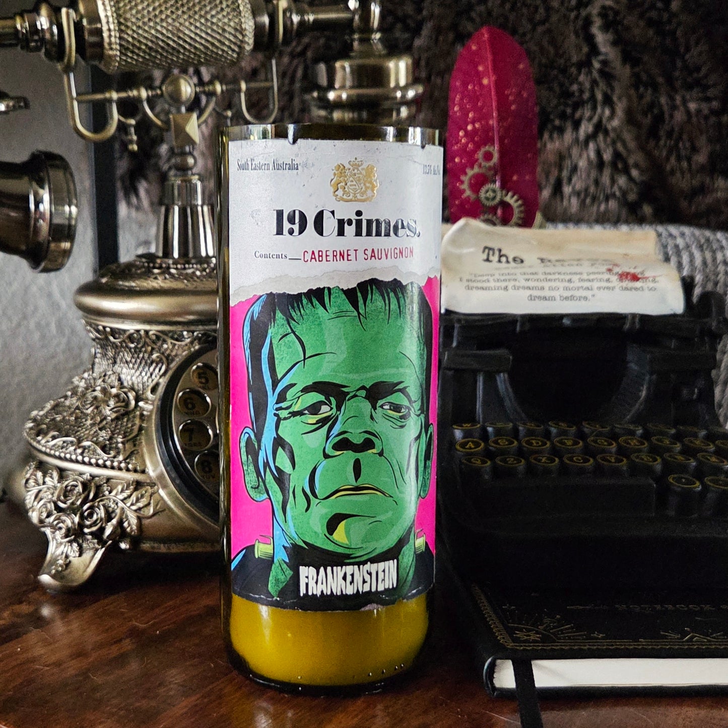 Front-facing 19 Crimes Frankenstein wine bottle candle featuring vivid green and magenta artwork of Frankenstein’s monster, hand-poured with coconut soy wax and a wooden wick in a recycled bottle.