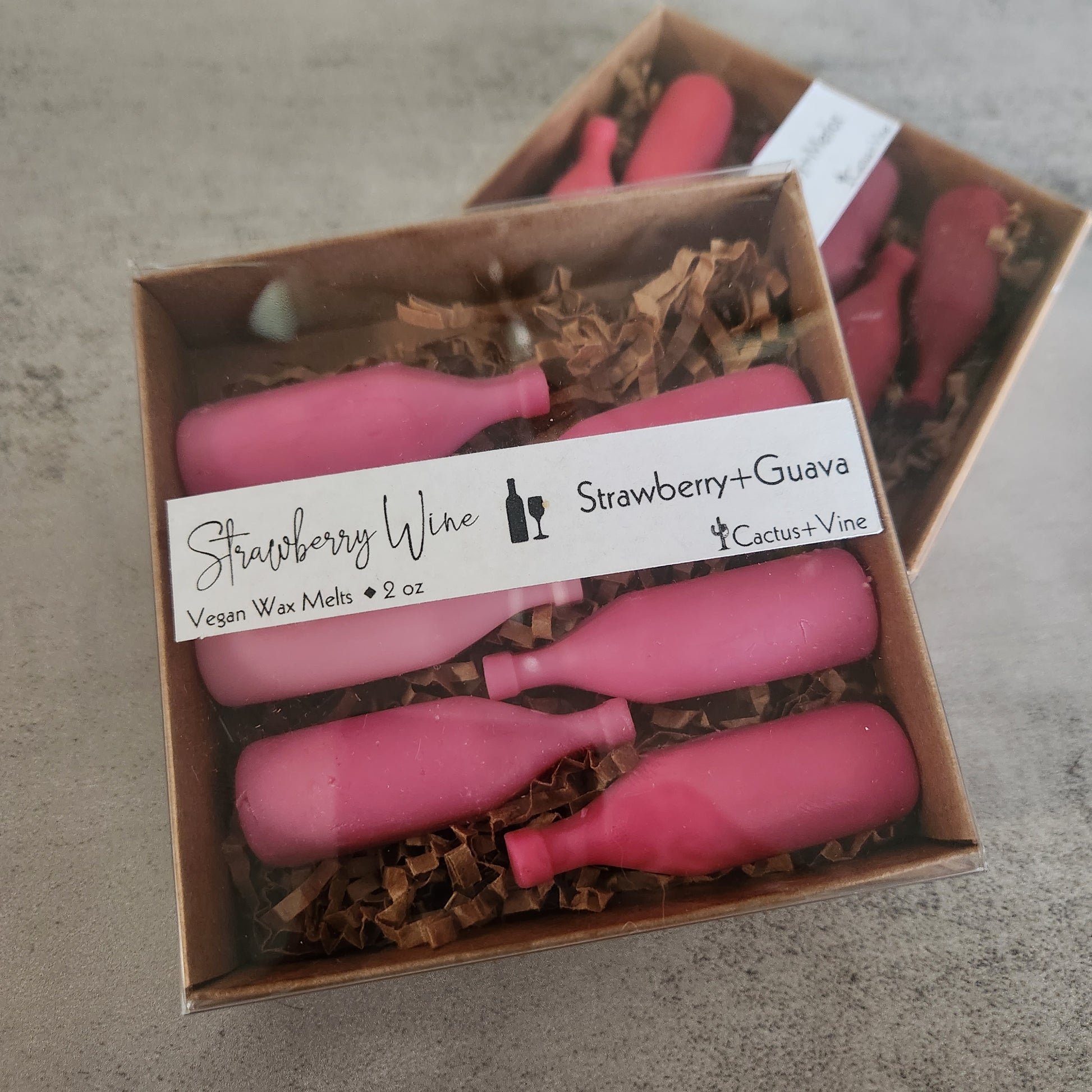 Boxed "Strawberry Wine" wax melts with label showing "Strawberry Guava" scent, highlighting the vegan wax melts made by Cactus Vine.