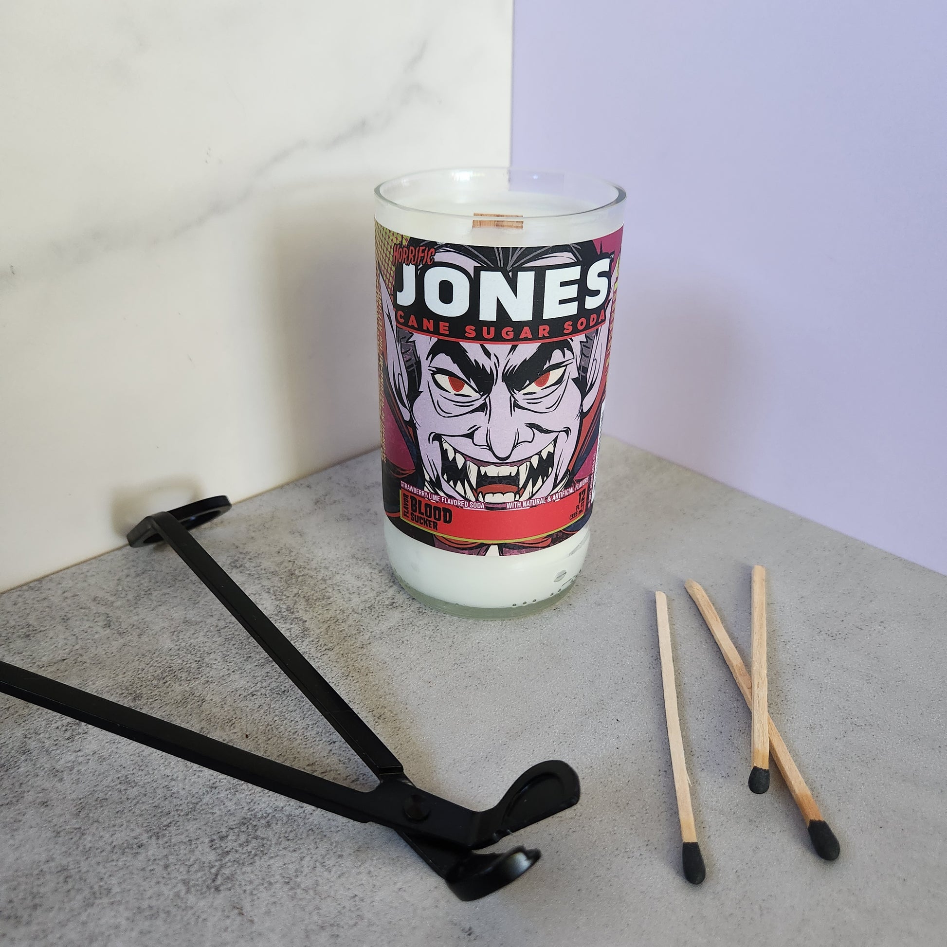 Jones soda bottle candle featuring a vampire label, hand-poured with eco-friendly coconut-soy wax and wooden wick, perfect for Halloween.