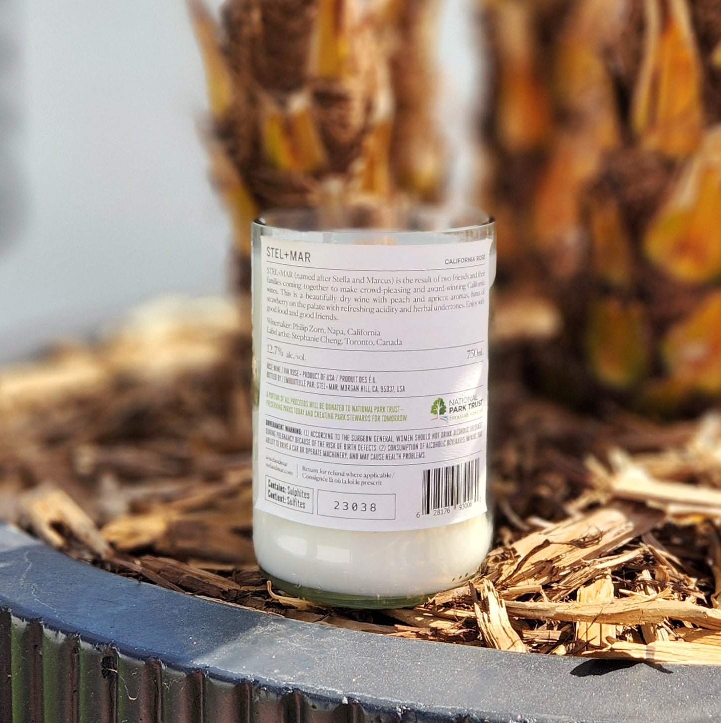 Back label view of an eco-friendly Stel + Mar California Rosé bottle candle, repurposed into a clean-burning coconut soy wax candle with a wooden wick.

