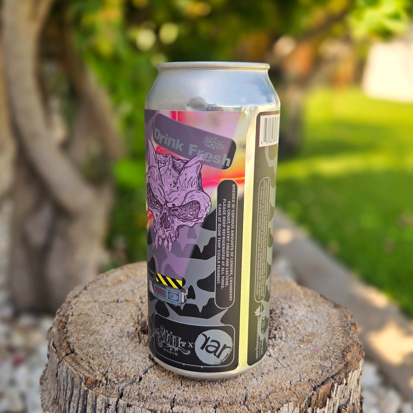 Eco-friendly beer can candle made from a recycled RAR Brewing can featuring purple horror-style artwork with a horned skull and “Drink Fresh” label. This upcycled candle is hand-poured with coconut soy wax and a wooden wick for a clean burn, perfect for horror fans or craft beer collectors.