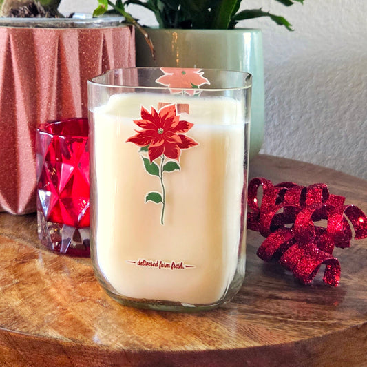 Candle with floral design on a wooden surface with decorative elements