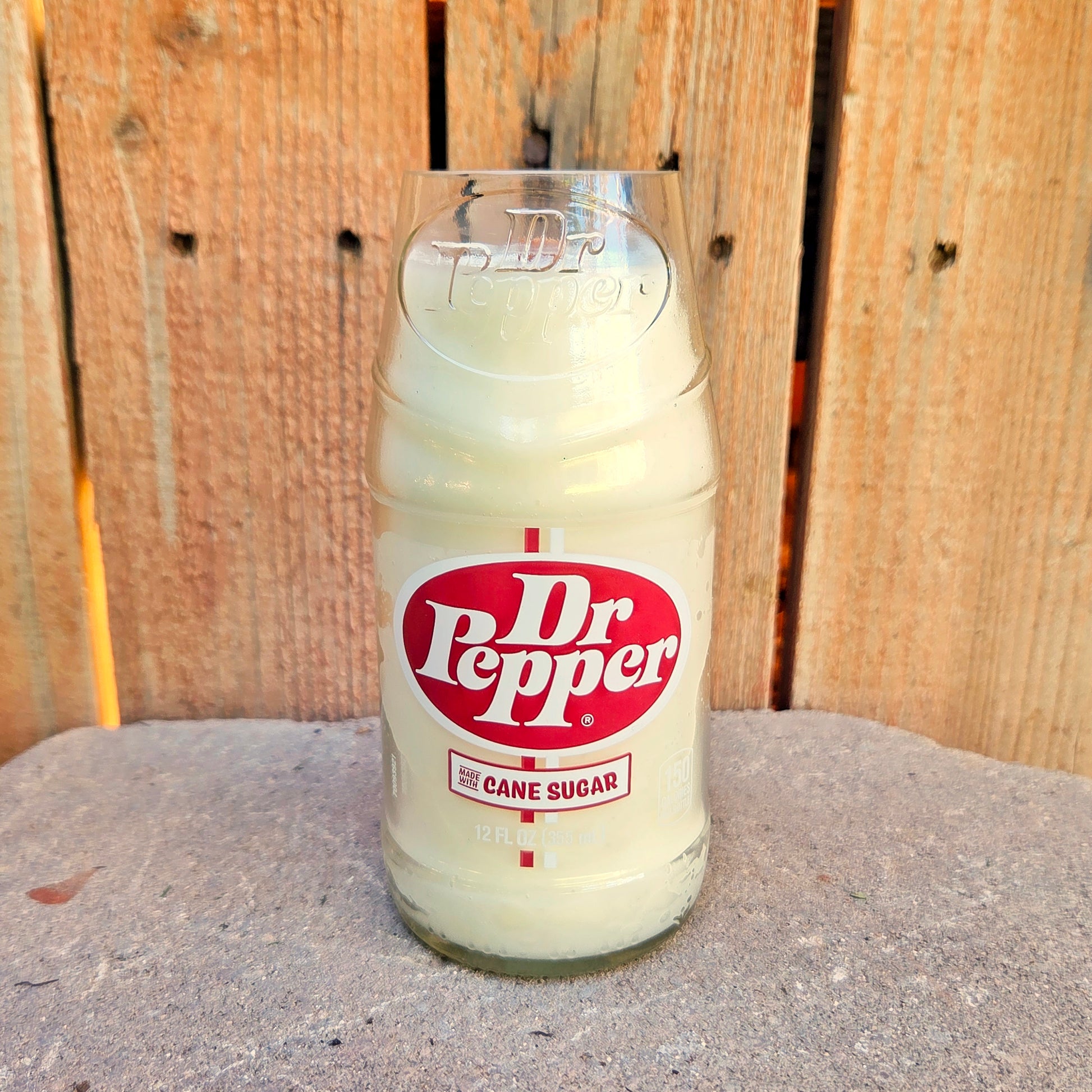 Dr Pepper glass bottle candle with a wooden background