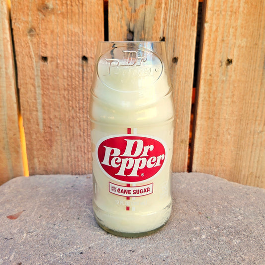 Dr Pepper glass bottle candle with a wooden background