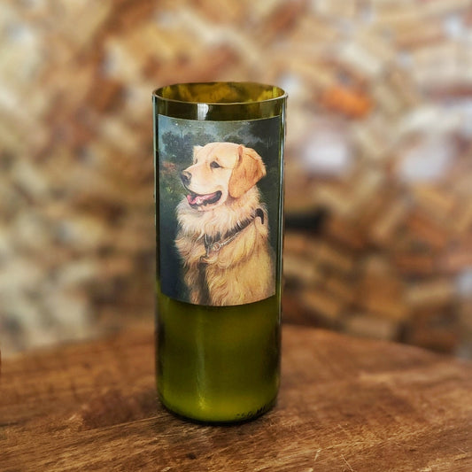 Front-facing shot of the Golden Dog wine bottle candle, with a warm-toned illustration of a golden retriever printed on the label.

