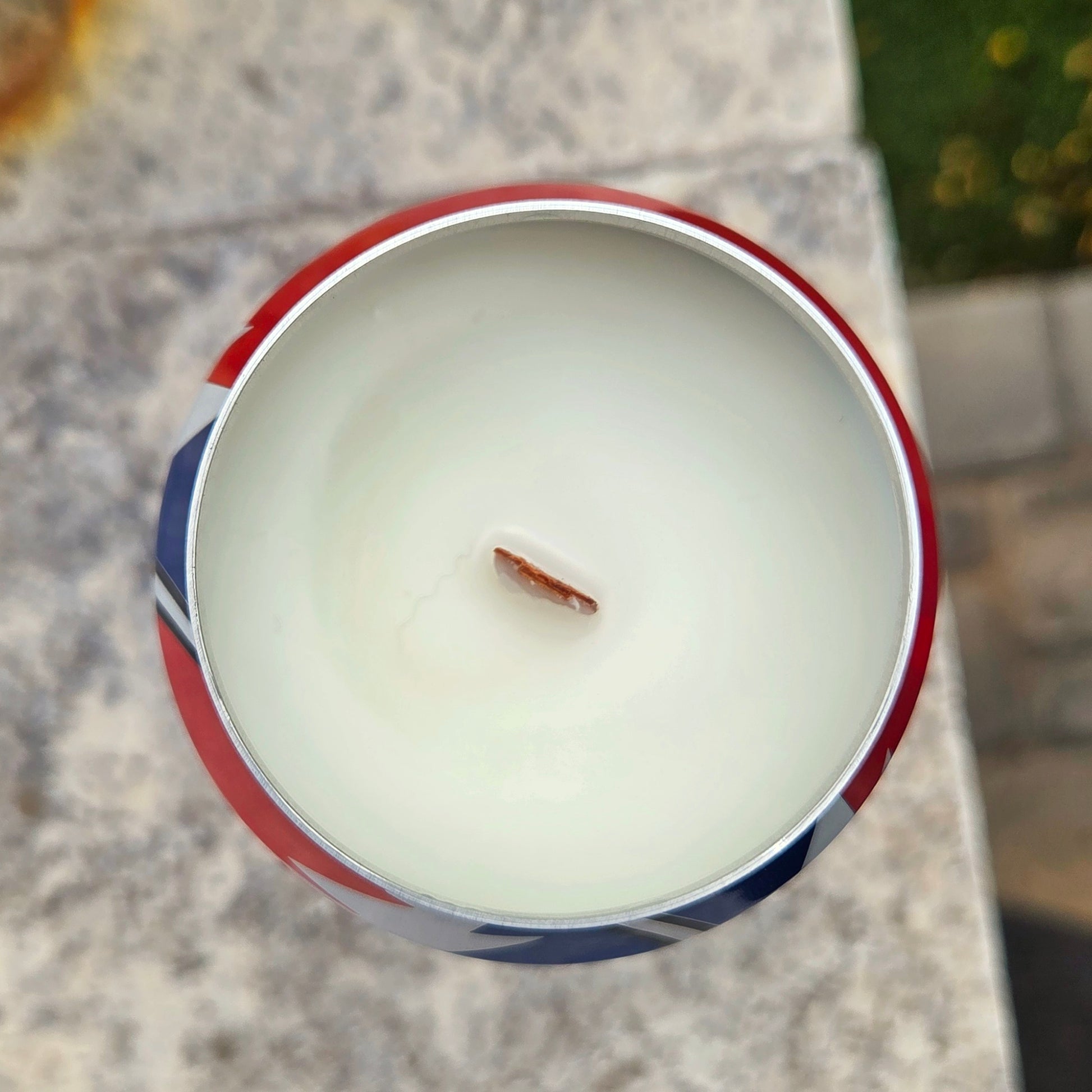 Top-down view of a clean-burning candle inside a recycled beer can, filled with creamy white coconut soy wax and a centered wooden wick, framed by the can’s silver rim.