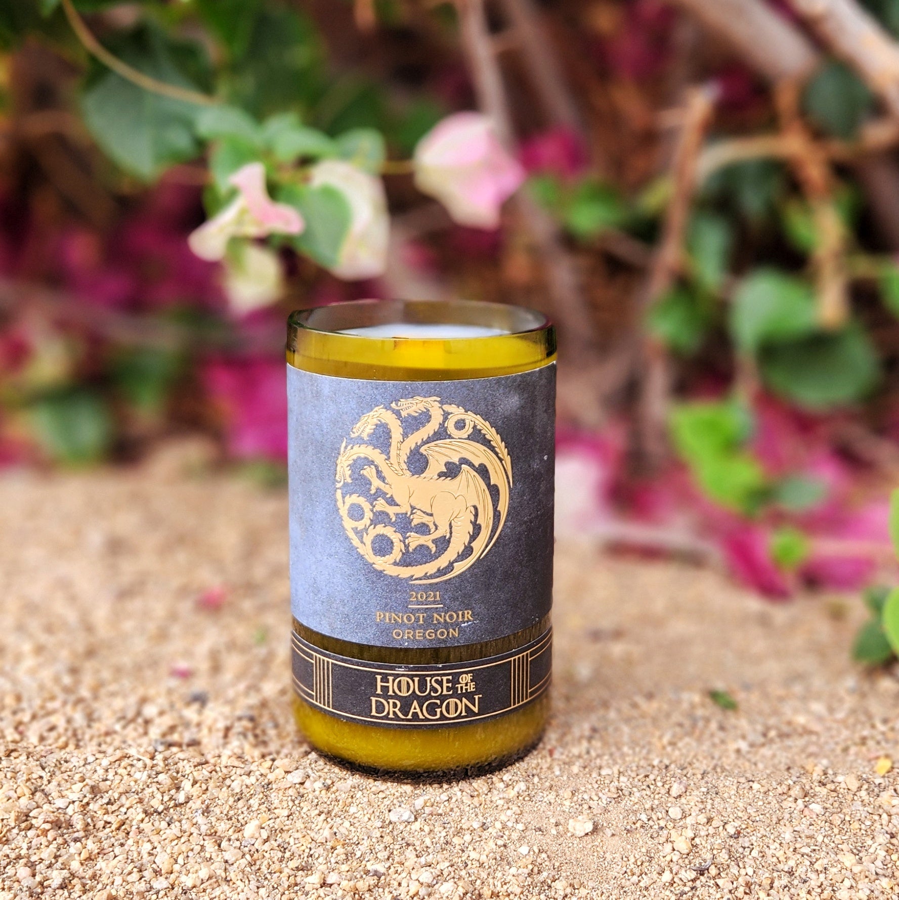 Hand-poured coconut soy wax candle with wooden wick in a recycled wine bottle featuring a House of the Dragon-inspired Pinot Noir label, crafted for eco-friendly decor with a bold fantasy vibe.