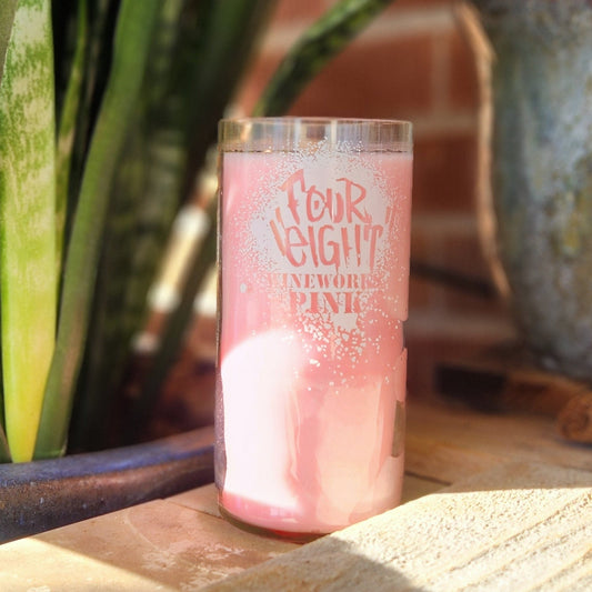 Brighten your space with this hand-poured candle in a recycled Four Eight Wineworks Pink wine bottle. Featuring a delicate pink hue and an etched label, it’s a charming, eco-friendly addition to your decor.