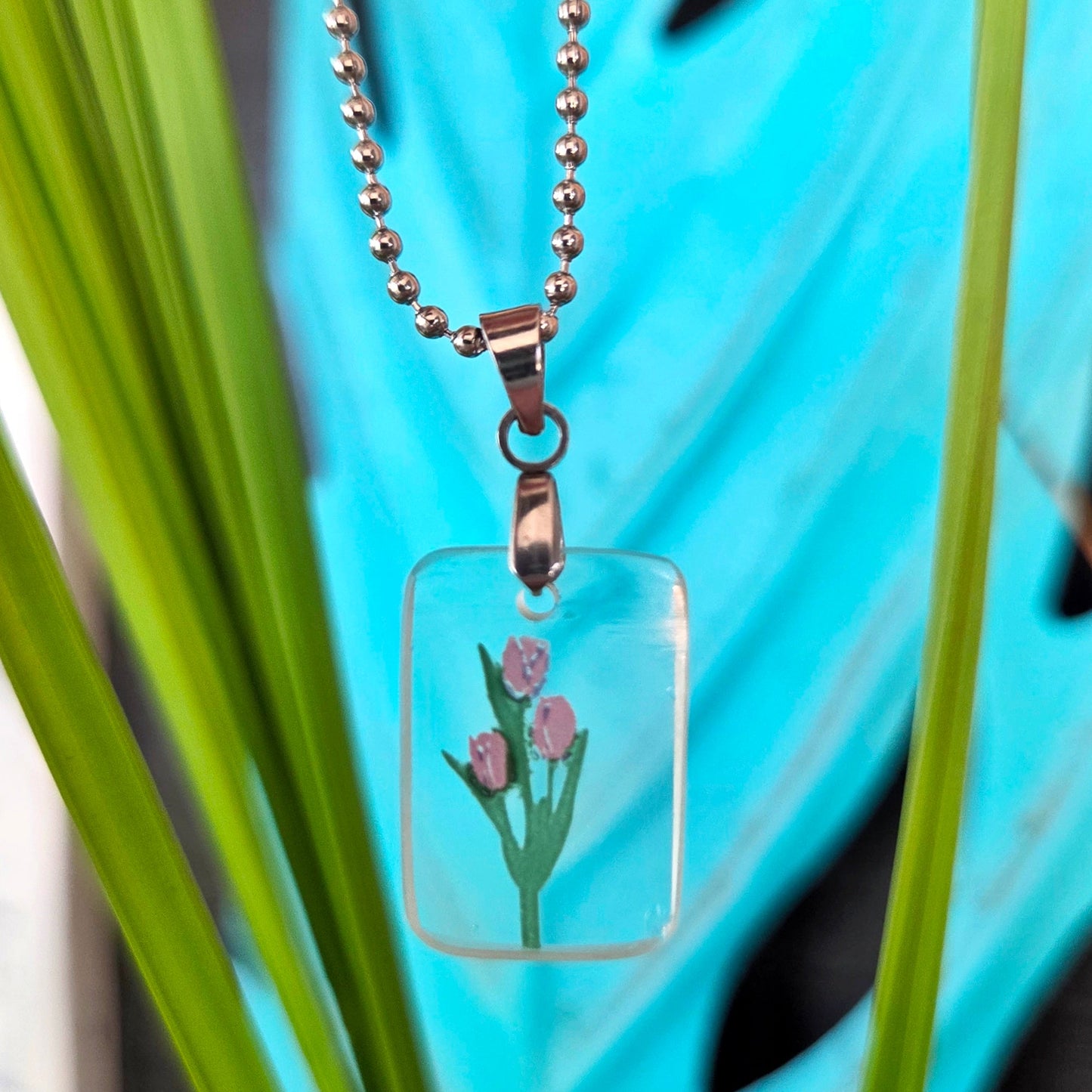 Recycled milk bottle glass tulip pendant necklace on a silver toned ball chain