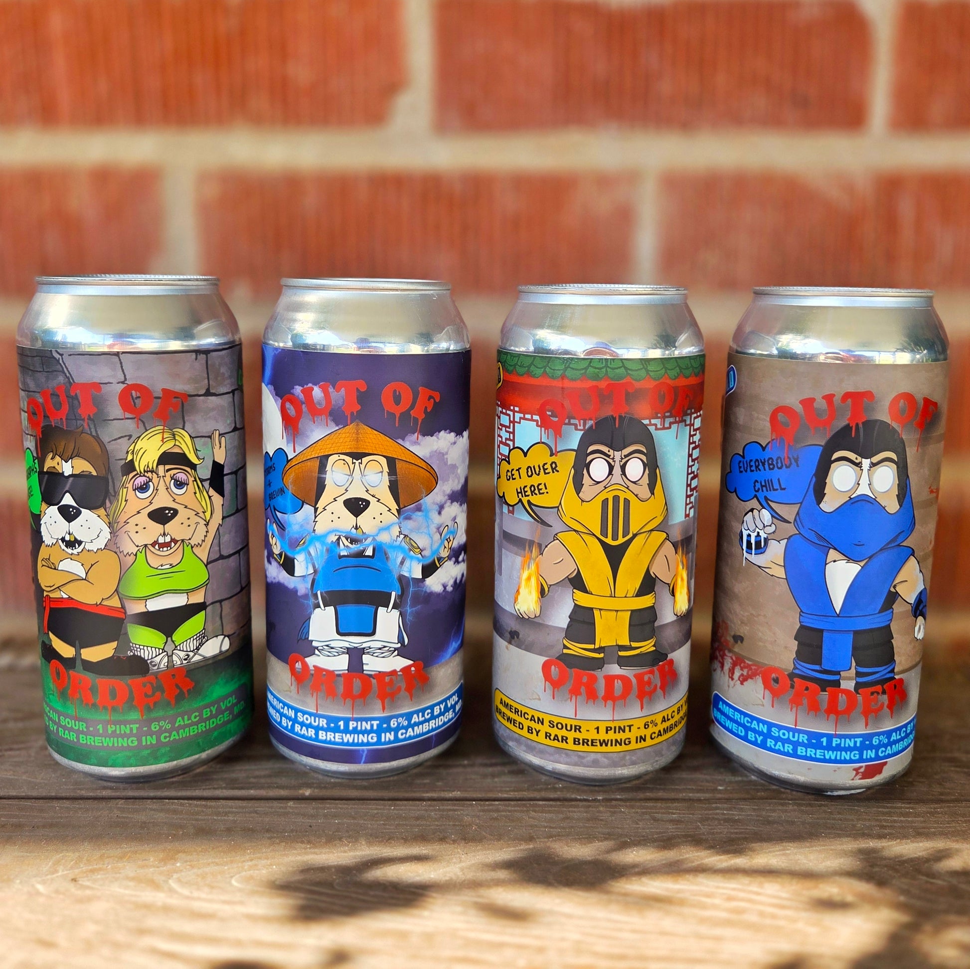 Lineup of four upcycled beer can candles with playful Mortal Kombat-inspired cartoon dog labels, including characters styled after Sonya Blade, Raiden, Scorpion, and Sub-Zero. Each candle is hand-poured with coconut soy wax and a wooden wick, offering a sustainable and fun home décor piece.