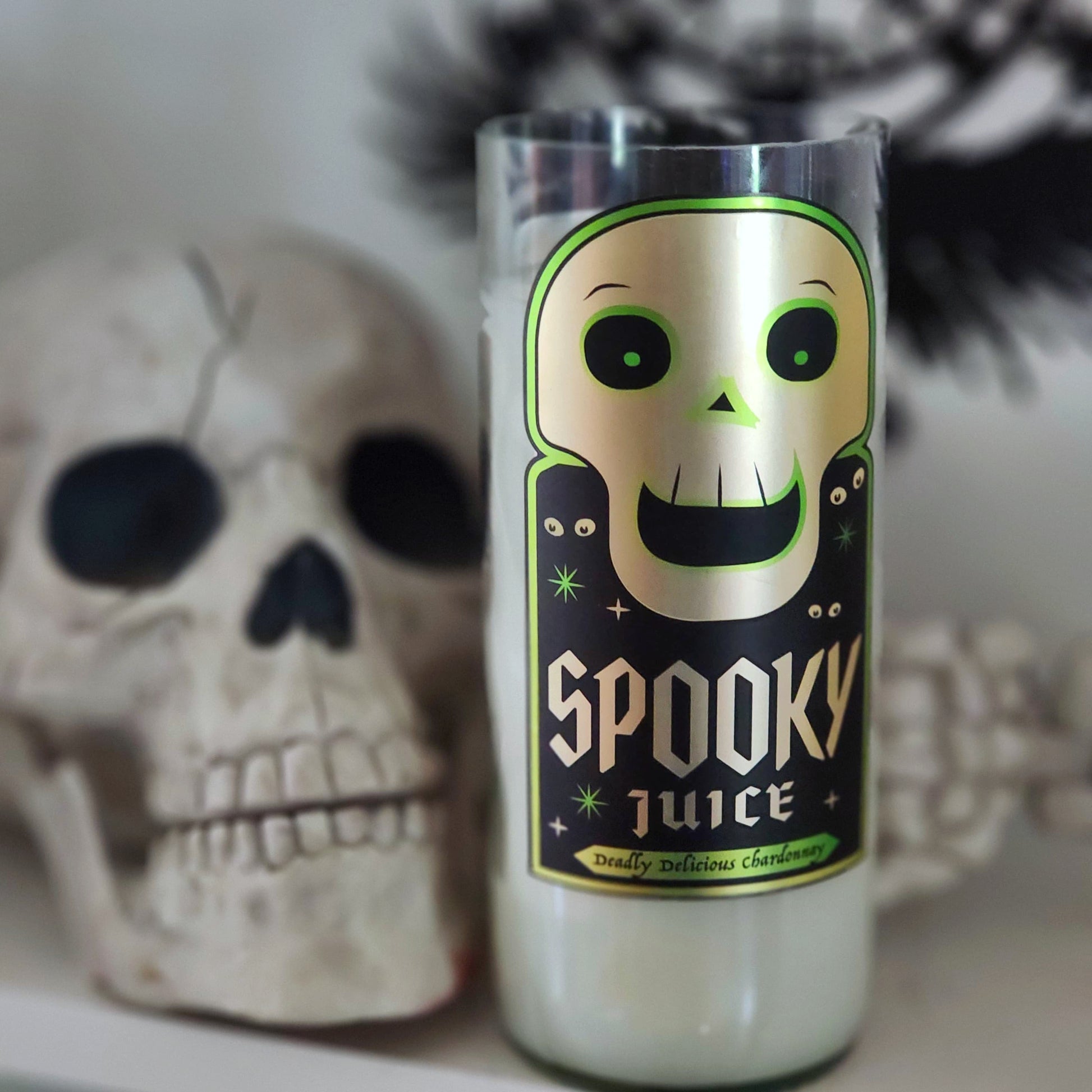 Wine Bottle candle labeled 'Spooky Juice' with a skull in the background