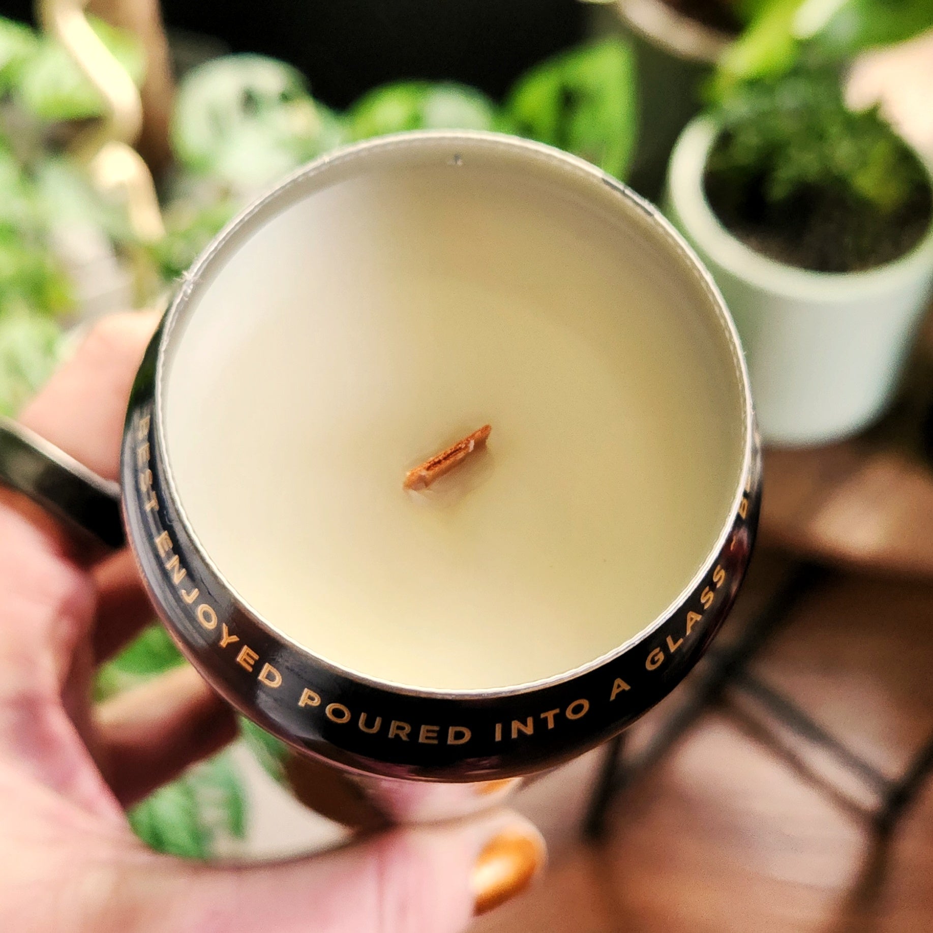 Overhead view of a creamy coconut soy candle with a wooden wick in a repurposed beer can—eco-conscious and toxin-free.