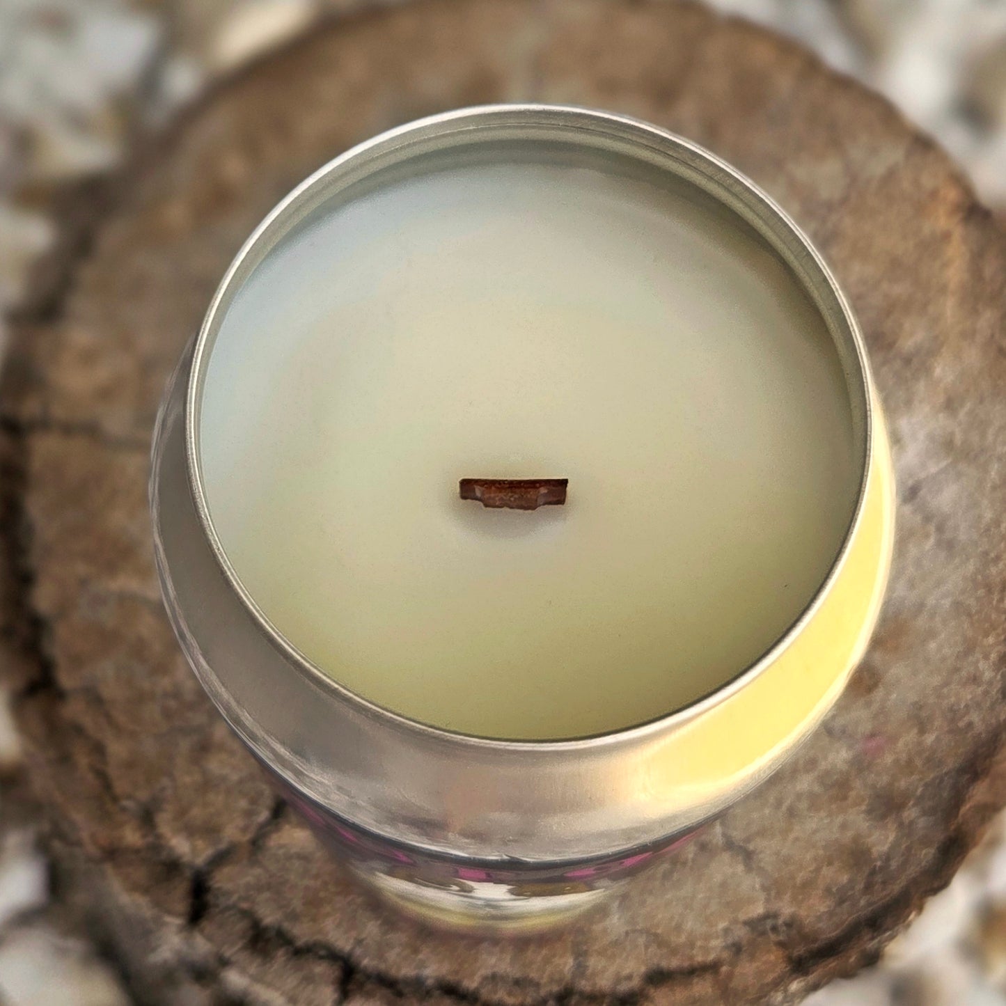 Close-up top view of a handcrafted beer can candle filled with smooth coconut soy wax and a centered wooden wick, showcasing the clean, minimalist surface of this eco-friendly upcycled candle.