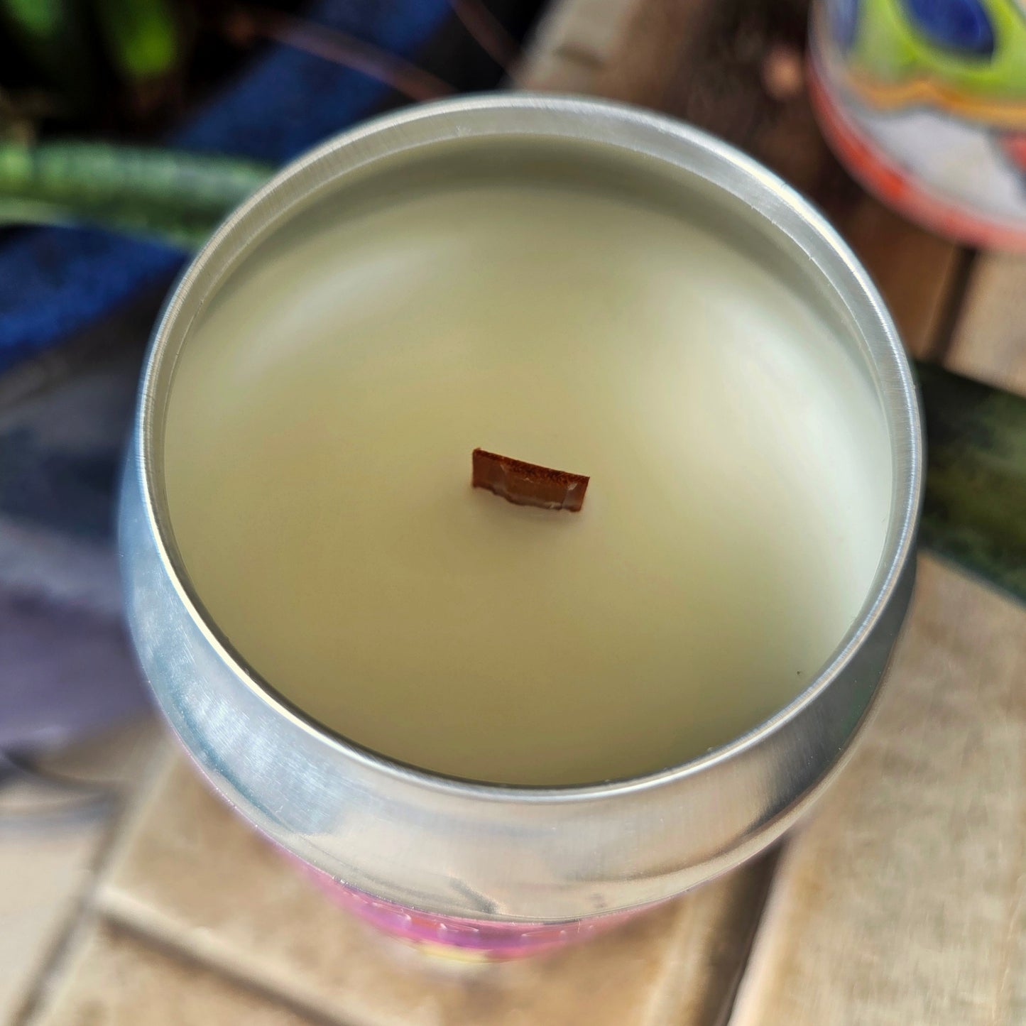 Top-down view of a hand-poured beer can candle filled with smooth coconut soy wax and centered wooden wick. This clean-burning, eco-friendly candle is crafted from a recycled craft beer can and offers a bold visual finish.