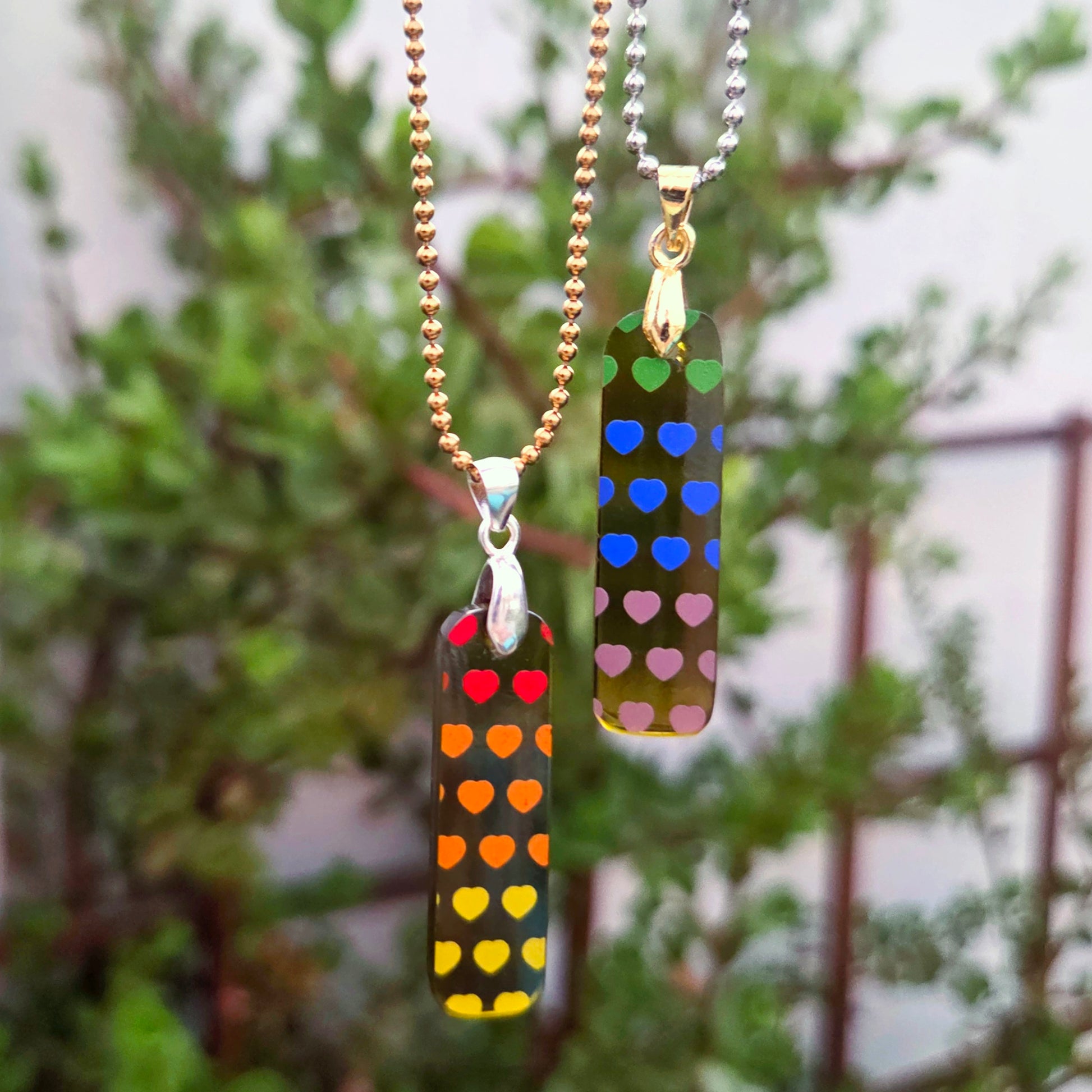 Set of two BFF heart necklaces made from recycled Prosecco bottle glass with colorful heart patterns