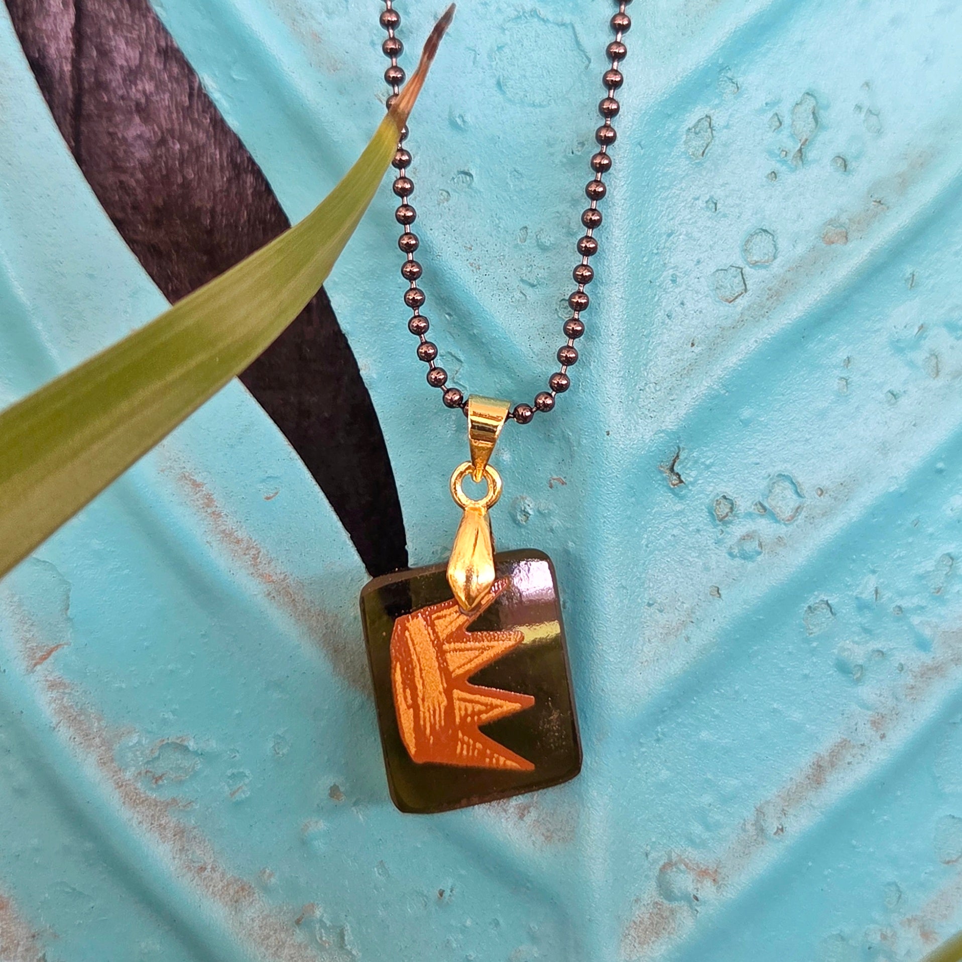 Amber recycled wine bottle glass necklace with gold crown design and handcrafted pendant