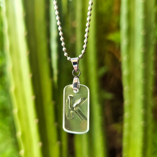 Letter K initial necklace made from clear recycled whiskey bottle glass with original raised lettering
