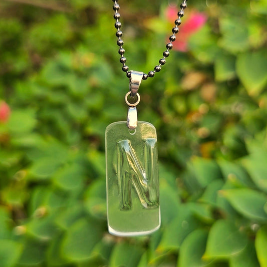 Letter N initial necklace made from clear recycled bourbon bottle glass with original raised lettering