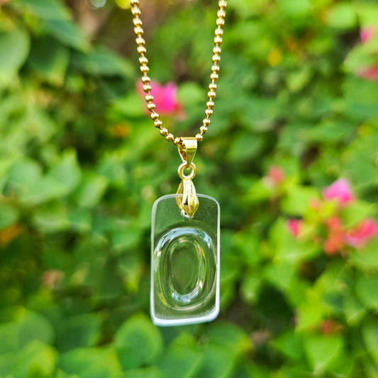 Letter O initial necklace made from clear recycled bourbon bottle glass with original raised lettering