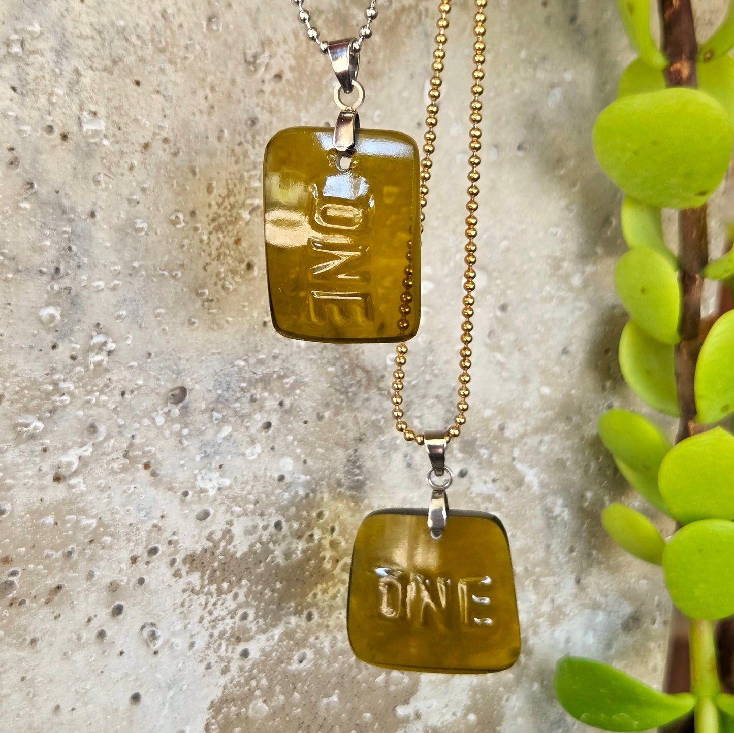 Two ONE necklaces made from recycled wine bottle glass with original raised lettering in vertical and horizontal styles