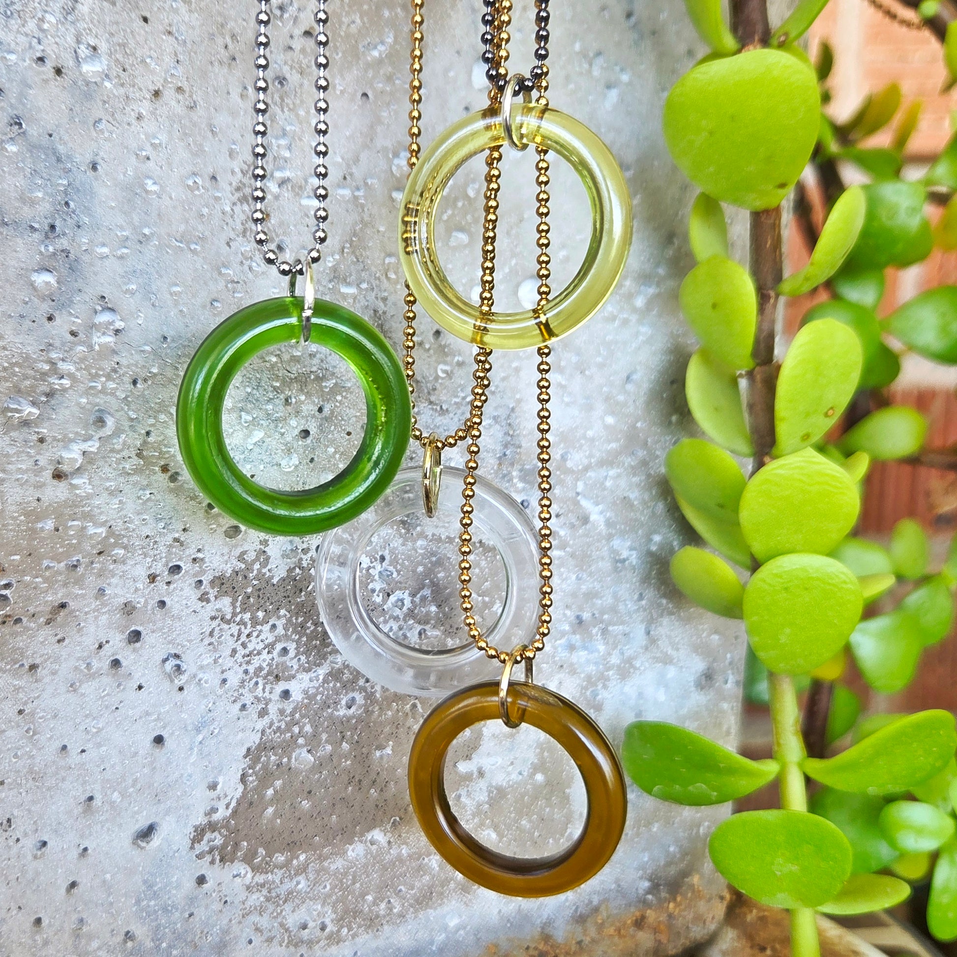 Recycled bottle glass circle necklaces in green, clear, amber and yellow-green glass