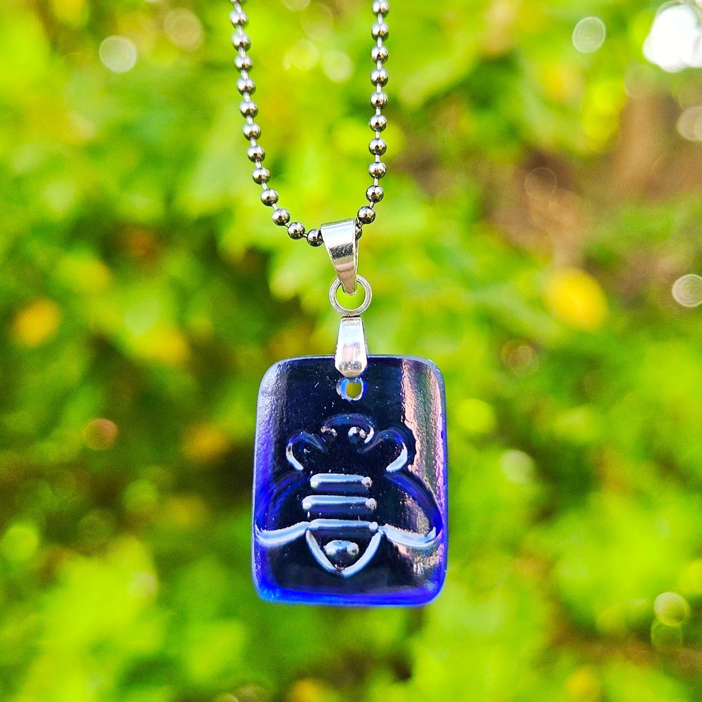 Blue recycled kombucha bottle glass honey bee pendant necklace on a gunmetal-toned ball chain