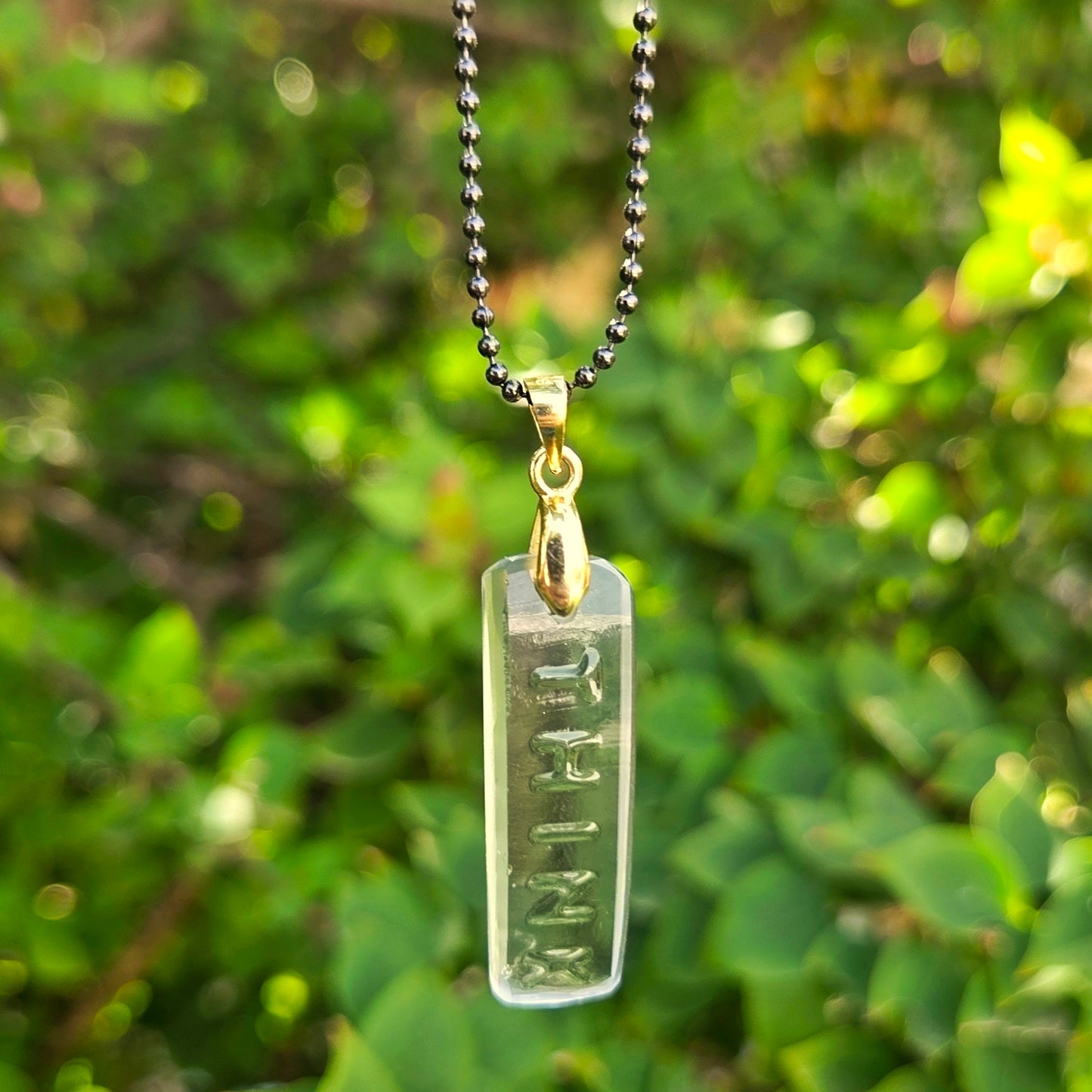 Recycled vodka bottle glass “Think” pendant necklace on a gold-toned bail with gunmetal ball chain