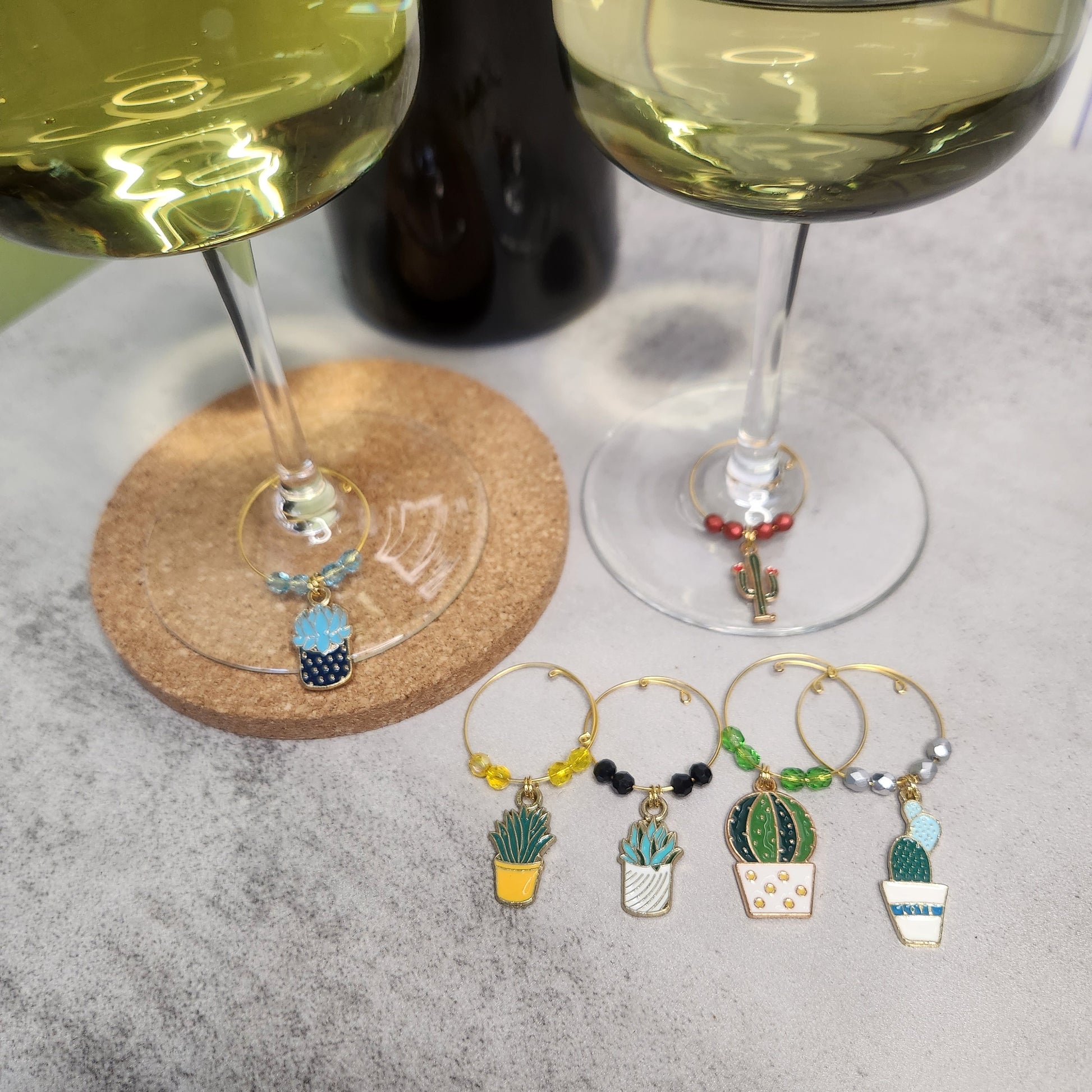 Wine glasses adorned with cactus and succulent charms, perfect for adding a personalized touch to any drinkware collection.