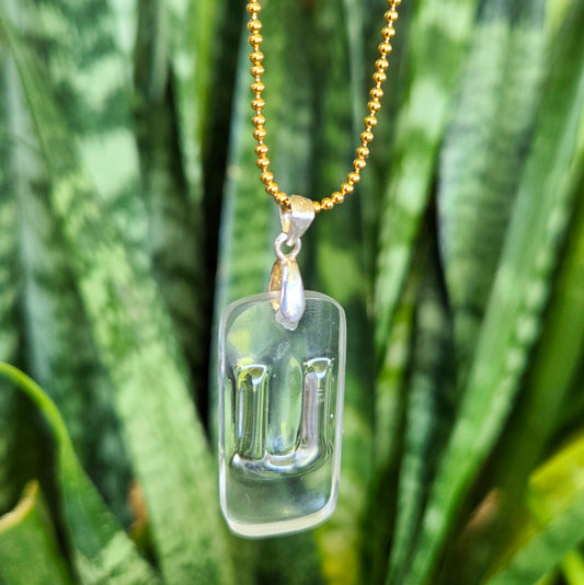 Letter U initial necklace made from clear recycled bourbon bottle glass with original raised lettering