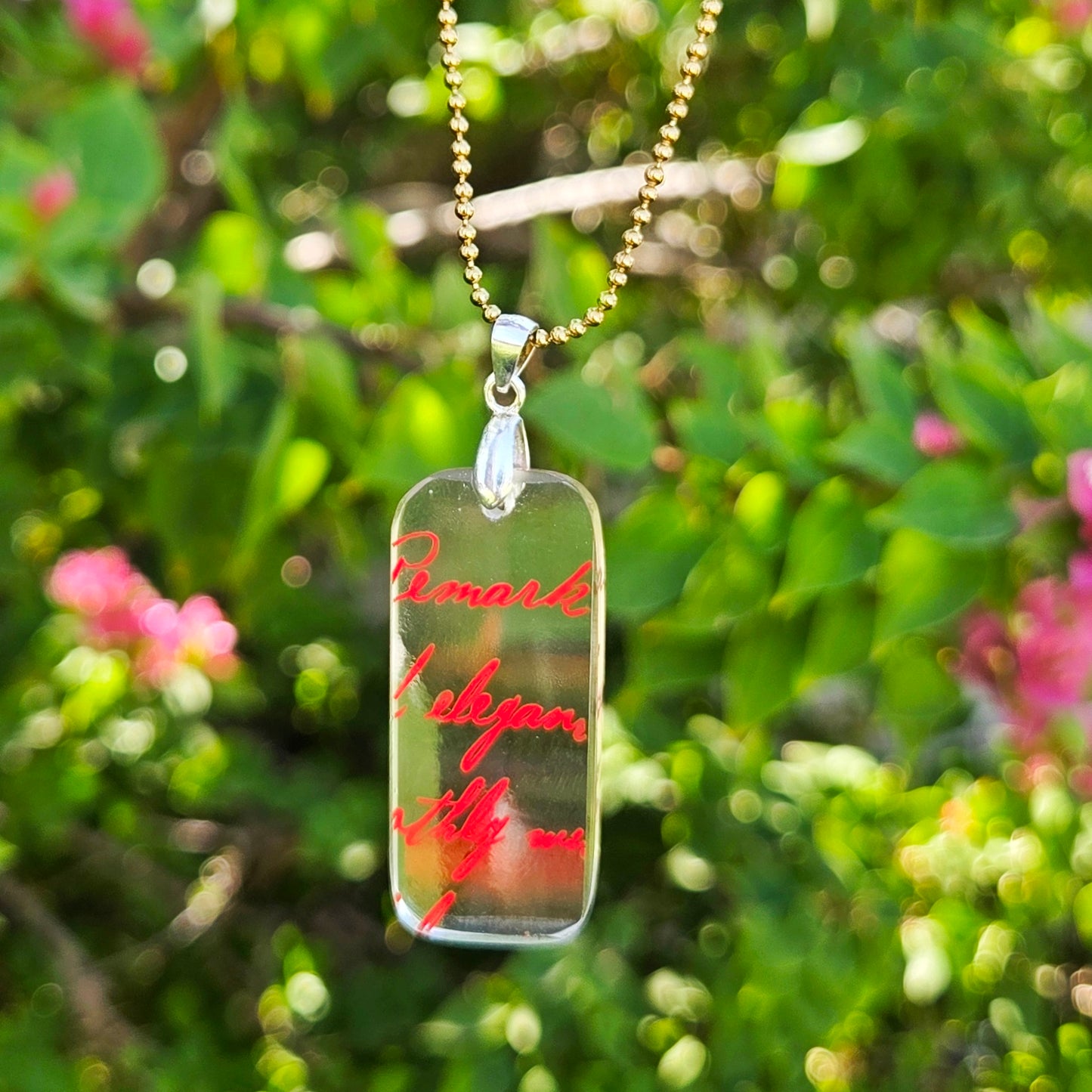 Clear recycled vodka bottle glass necklace with original red lettering and handcrafted pendant
